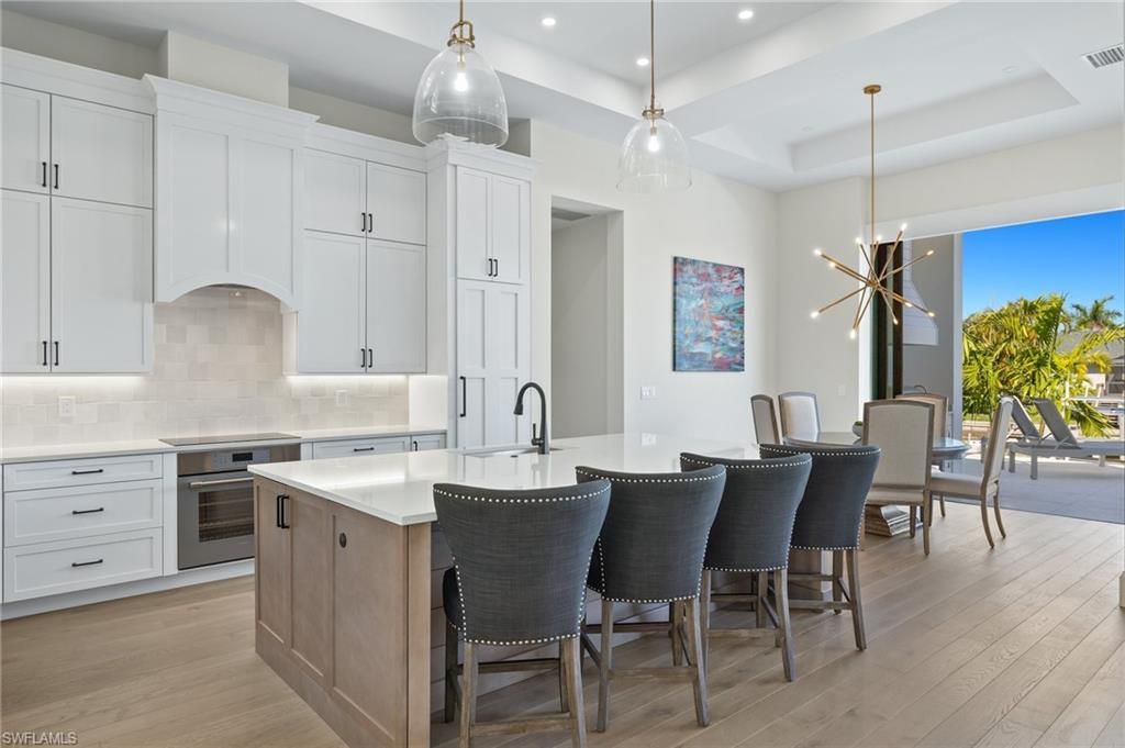 Dining room, Interior, Kitchen, Pendant Lights, Recessed Lighting, Stainless Steel Appliances, Wood Texture Flooring