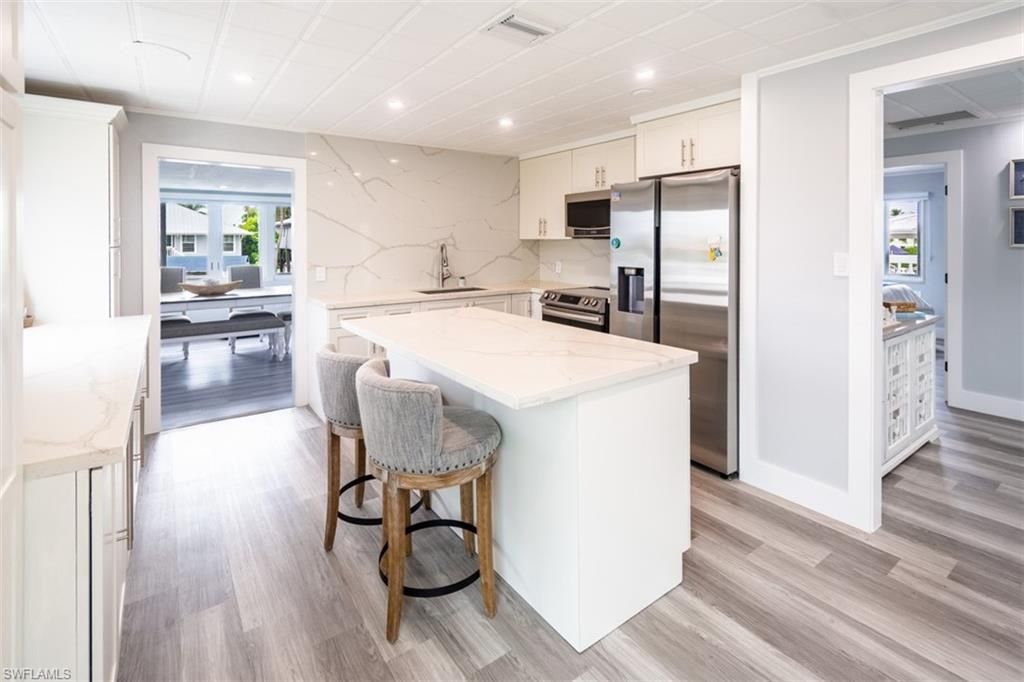 Interior, Kitchen, Marble Walls, Recessed Lighting, Stainless Steel Appliances, Wood Texture Flooring