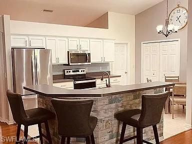 Chandelier, Interior, Kitchen, Pendant Lights, Stainless Steel Appliances, Wood Texture Flooring