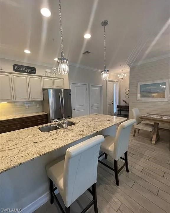 Chandelier, Dining room, Interior, Kitchen, Pendant Lights, Recessed Lighting, Stainless Steel Appliances, Wood Texture Flooring