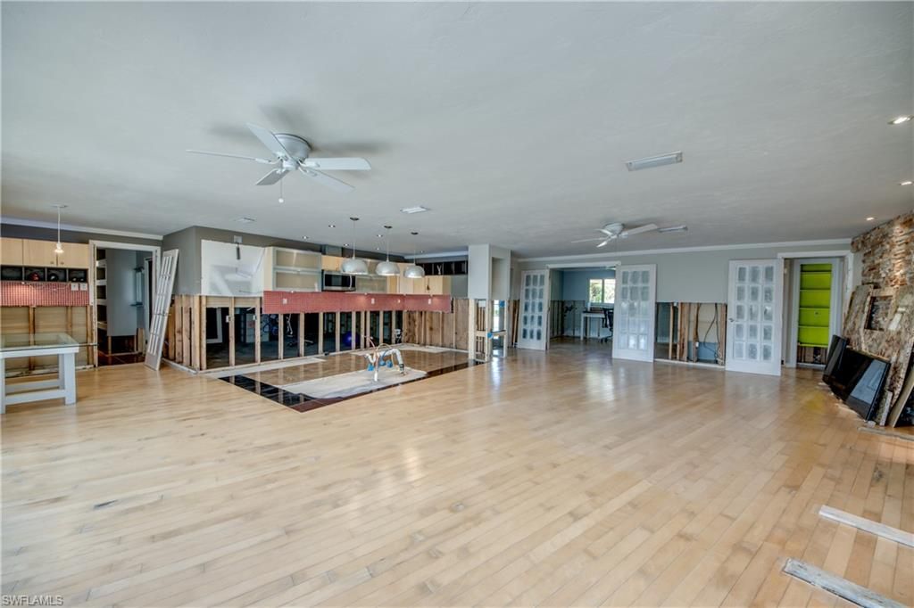 Empty room, Fireplace, Interior, Kitchen, Pendant Lights, Recessed Lighting, Stone Walls, Wood Texture Flooring