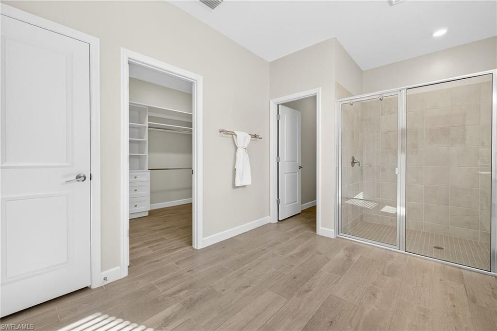 Bathroom, Glass Shower, Interior, Recessed Lighting, Walk-in Closets, Wood Texture Flooring