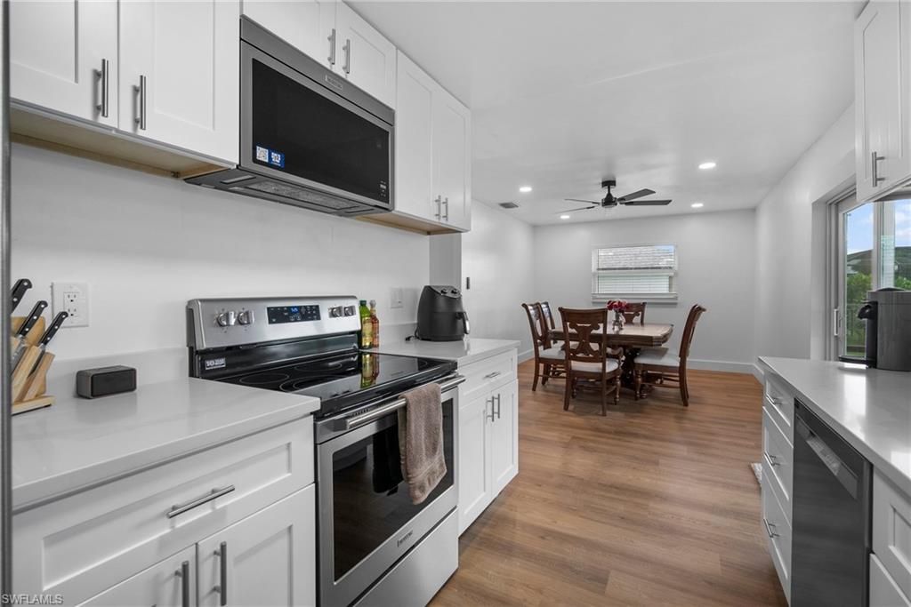 Dining room, Interior, Kitchen, Recessed Lighting, Stainless Steel Appliances, Wood Texture Flooring