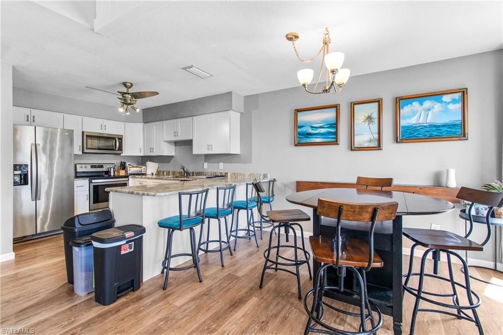 Chandelier, Dining room, Interior, Kitchen, Pendant Lights, Stainless Steel Appliances, Wood Texture Flooring