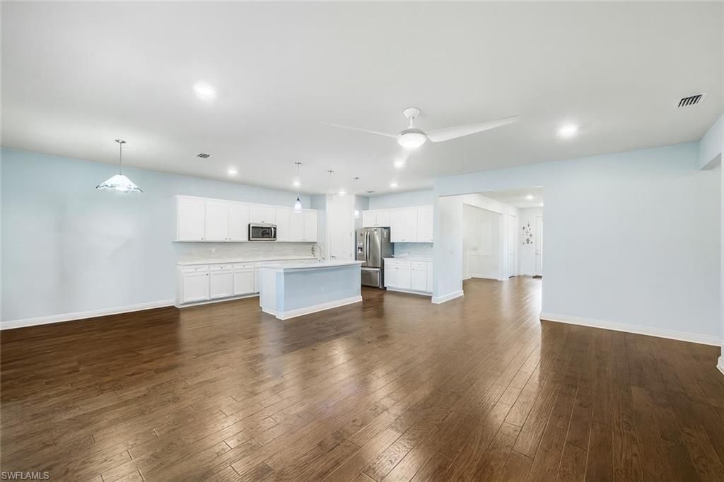 Empty room, Interior, Kitchen, Pendant Lights, Recessed Lighting, Stainless Steel Appliances, Wood Texture Flooring