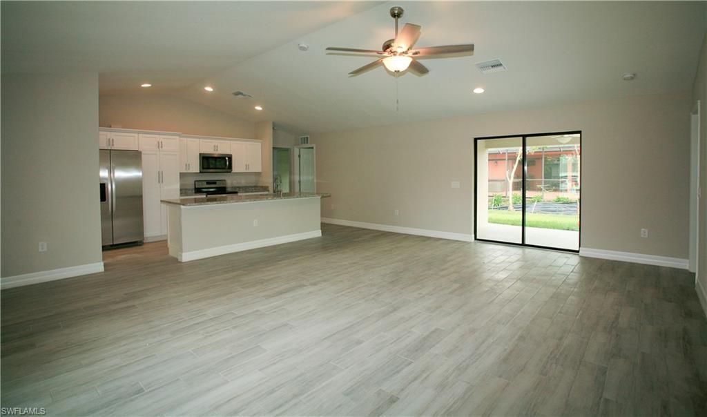 Empty room, Interior, Kitchen, Recessed Lighting, Stainless Steel Appliances, Wood Texture Flooring
