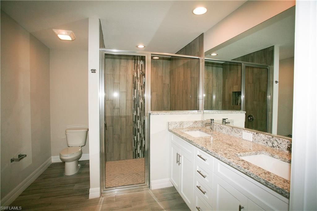 Bathroom, Dual Sink Vanities, Glass Shower, Interior, Recessed Lighting, Wood Texture Flooring