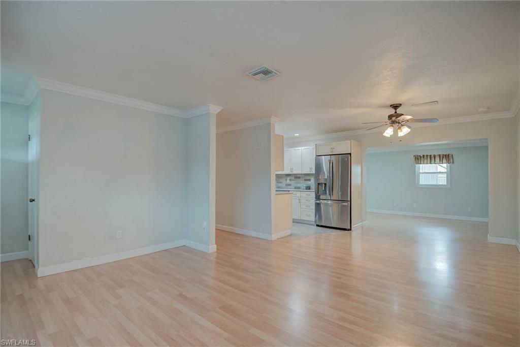 Empty room, Interior, Kitchen, Recessed Lighting, Stainless Steel Appliances, Wood Texture Flooring