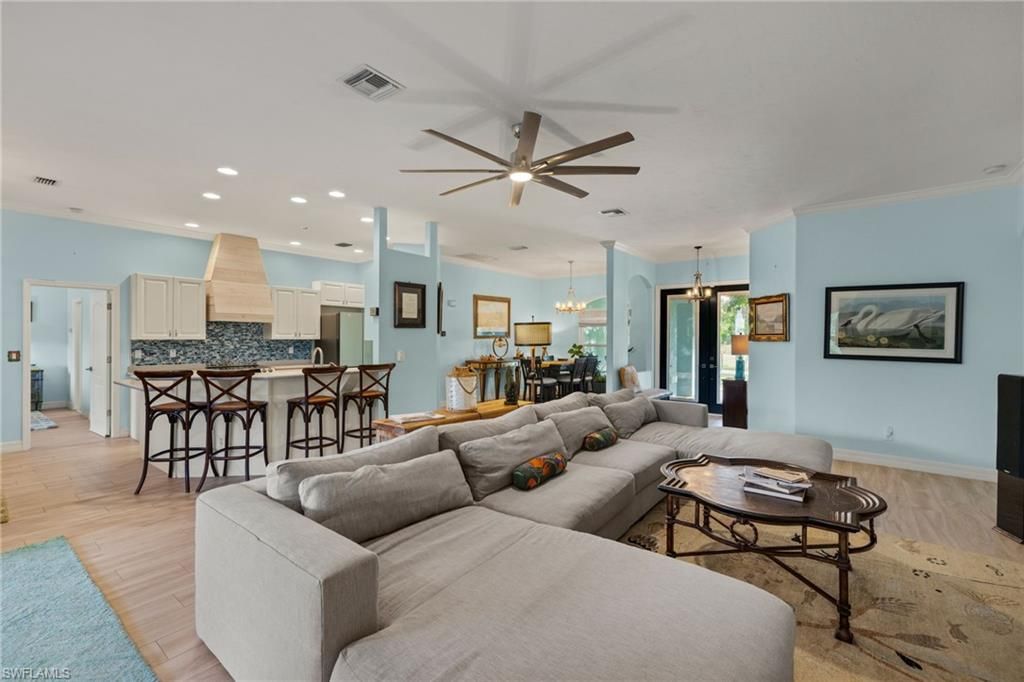 Chandelier, Dining room, Interior, Kitchen, Living room, Pendant Lights, Recessed Lighting, Stainless Steel Appliances, Wood Texture Flooring