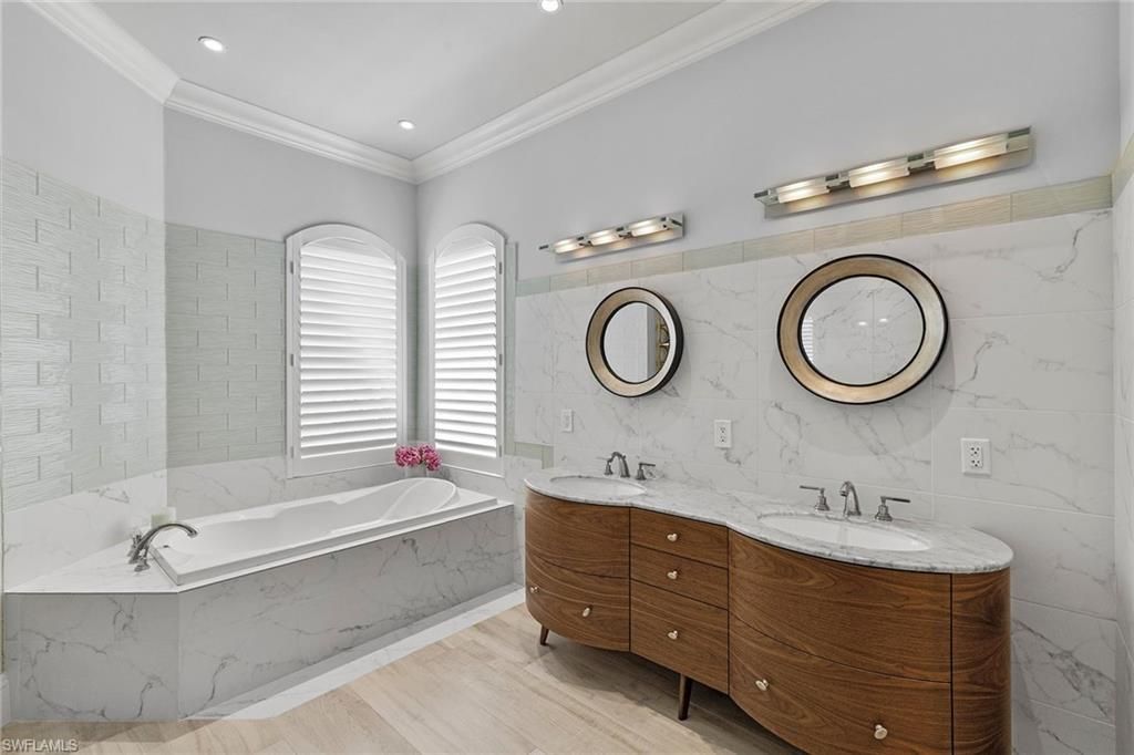 Bathroom, Dual Sink Vanities, Interior, Marble Walls, Recessed Lighting, Wood Texture Flooring