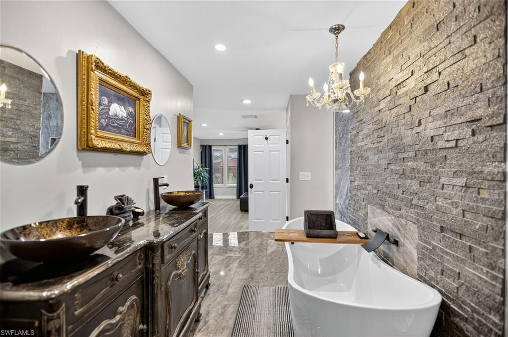 Bathroom, Chandelier, Dual Sink Vanities, Free Standing Baths, Interior, Marble, Recessed Lighting, Stone Walls