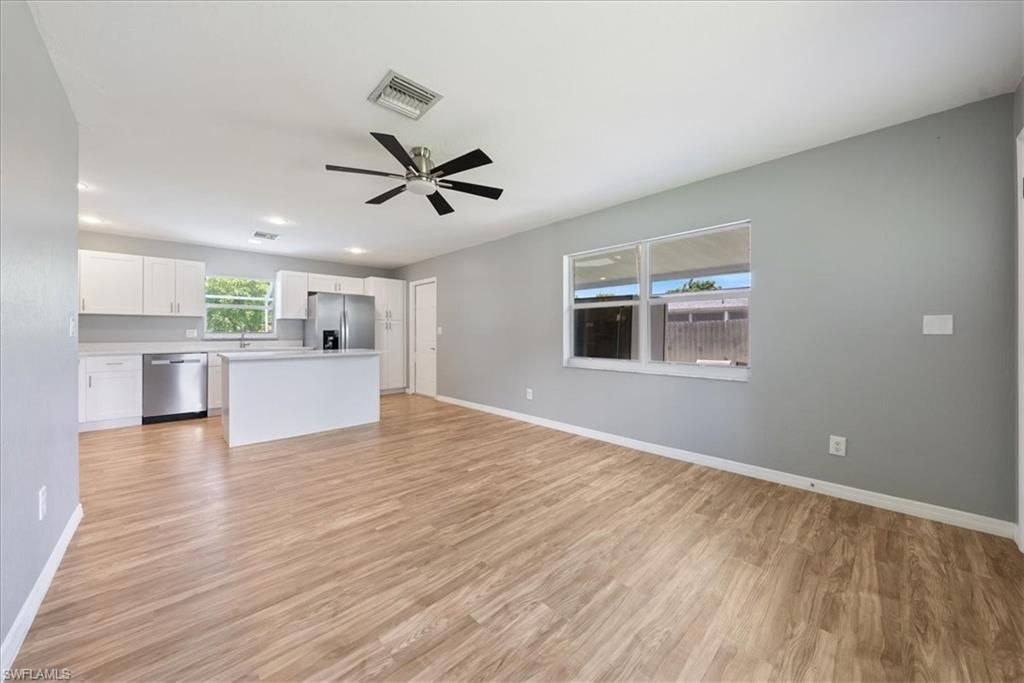 Empty room, Interior, Kitchen, Recessed Lighting, Stainless Steel Appliances, Wood Texture Flooring
