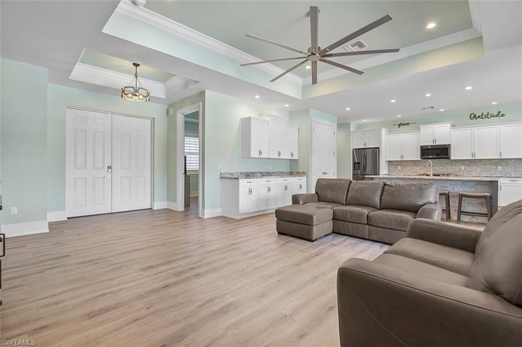 Chandelier, Interior, Kitchen, Living room, Pendant Lights, Recessed Lighting, Stainless Steel Appliances, Wood Texture Flooring
