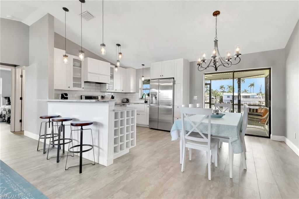Chandelier, Dining room, Interior, Kitchen, Pendant Lights, Stainless Steel Appliances, Wood Texture Flooring