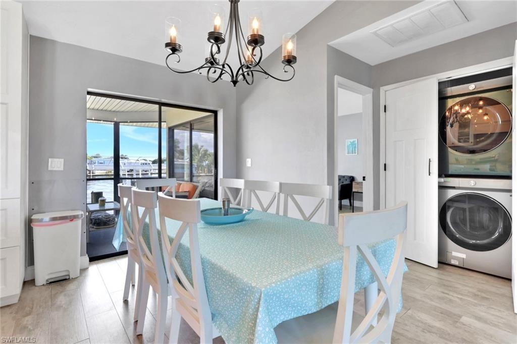 Chandelier, Dining room, Interior, Utility Closets, Washer, Water, Wood Texture Flooring