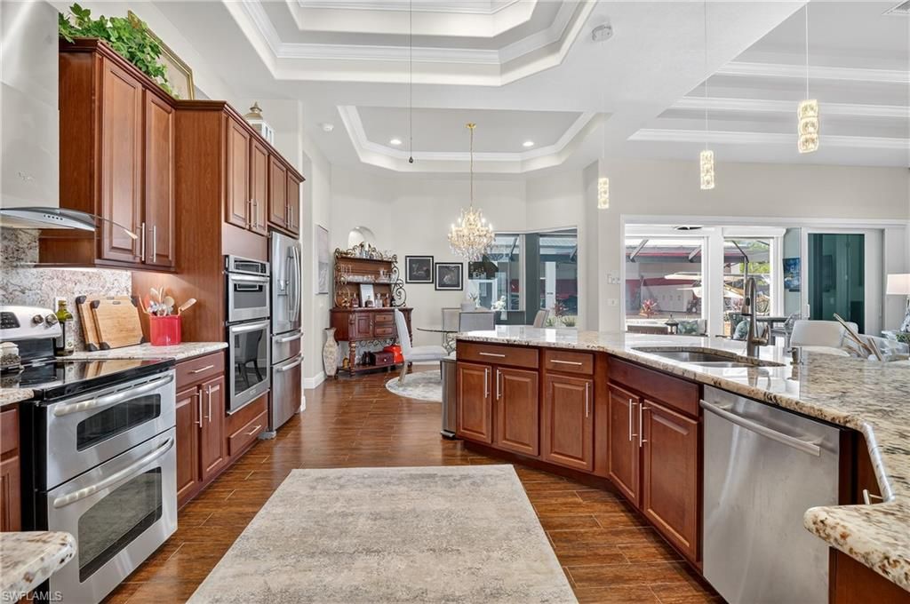 Chandelier, Dining room, Interior, Kitchen, Pendant Lights, Recessed Lighting, Stainless Steel Appliances, Wood Texture Flooring