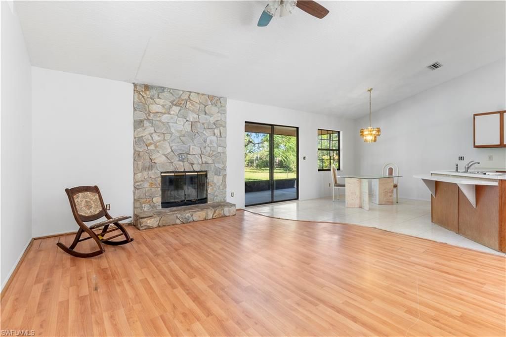Chandelier, Empty room, Fireplace, Interior, Pendant Lights, Stone Walls, Wood Texture Flooring