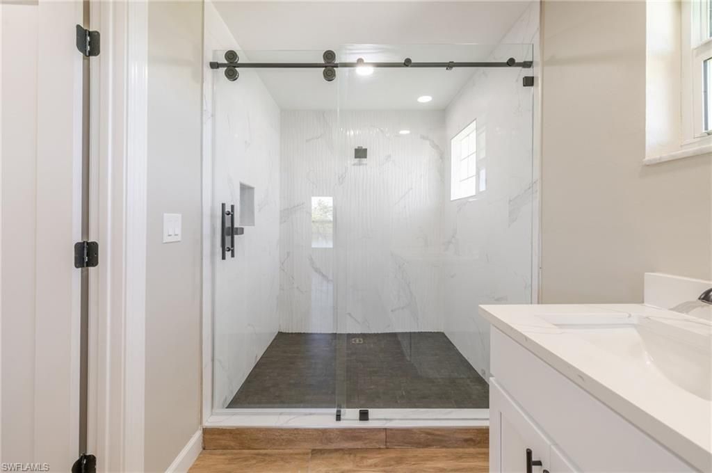 Bathroom, Glass Shower, Interior, Marble Walls, Recessed Lighting, Wood Texture Flooring