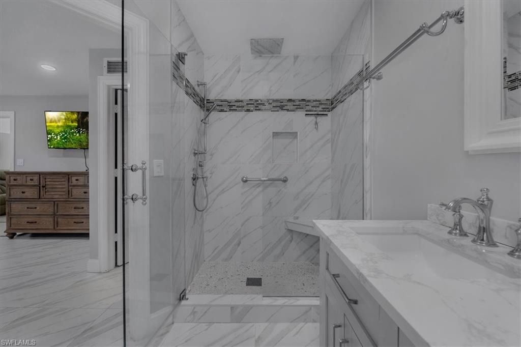 Bathroom, Dual Sink Vanities, Glass Shower, Interior, Marble, Marble Walls, Recessed Lighting