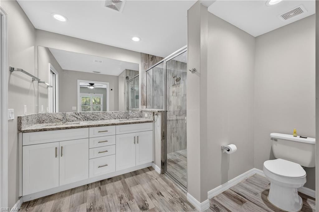 Bathroom, Dual Sink Vanities, Glass Shower, Interior, Recessed Lighting, Wood Texture Flooring