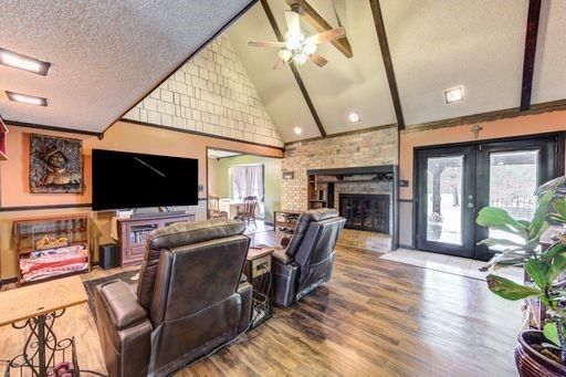 Fireplace, Interior, Living room, Recessed Lighting, Stone Walls, Wood Texture Flooring