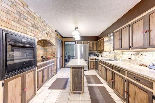 Interior, Kitchen, Pendant Lights, Stainless Steel Appliances, Stone Walls