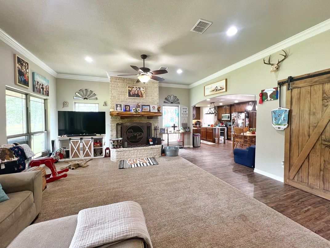 Fireplace, Interior, Living room, Recessed Lighting, Stone Walls, Wood Texture Flooring