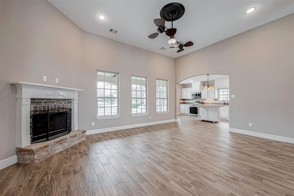 Chandelier, Empty room, Fireplace, Interior, Kitchen, Recessed Lighting, Wood Texture Flooring