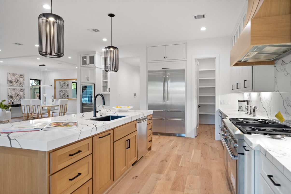 Dining room, Interior, Kitchen, Pendant Lights, Recessed Lighting, Stainless Steel Appliances, Wood Texture Flooring