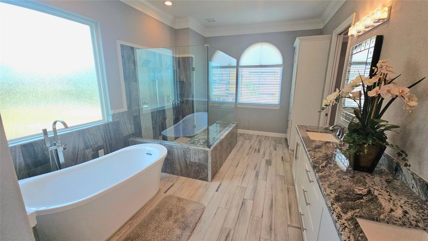 Bathroom, Dual Sink Vanities, Free Standing Baths, Glass Shower, Interior, Recessed Lighting, Wood Texture Flooring