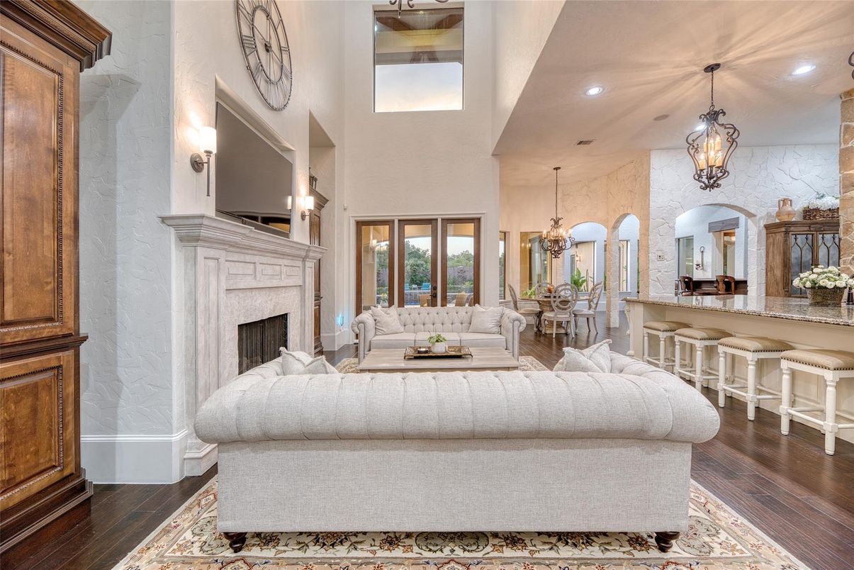 Chandelier, Dining room, Fireplace, Interior, Living room, Pendant Lights, Recessed Lighting, Wood Texture Flooring