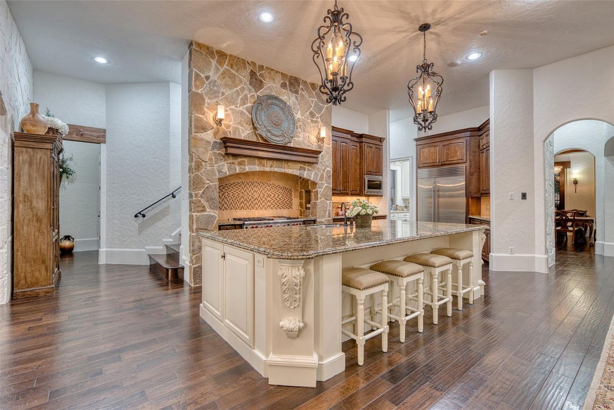 Fireplace, Interior, Kitchen, Pendant Lights, Recessed Lighting, Stainless Steel Appliances, Stone Walls, Wood Texture Flooring