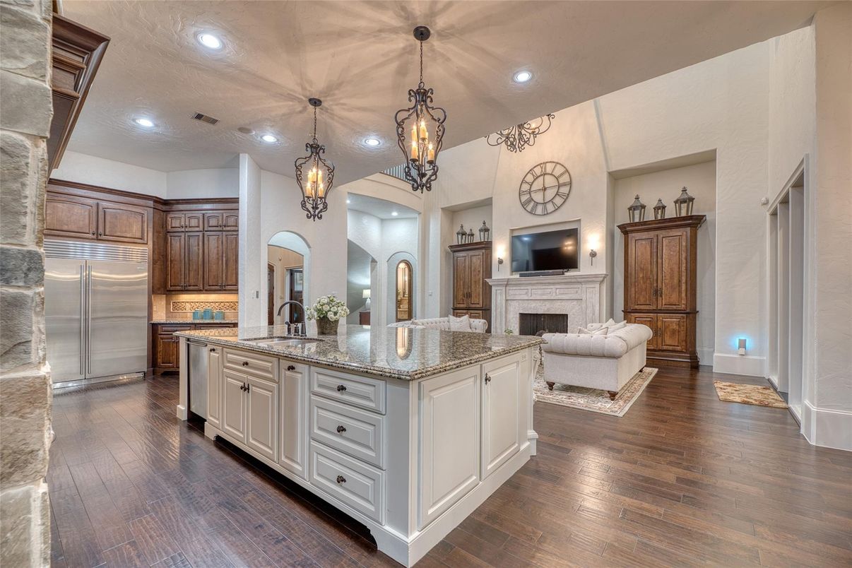 Fireplace, Interior, Kitchen, Living room, Pendant Lights, Recessed Lighting, Stainless Steel Appliances, Wood Texture Flooring