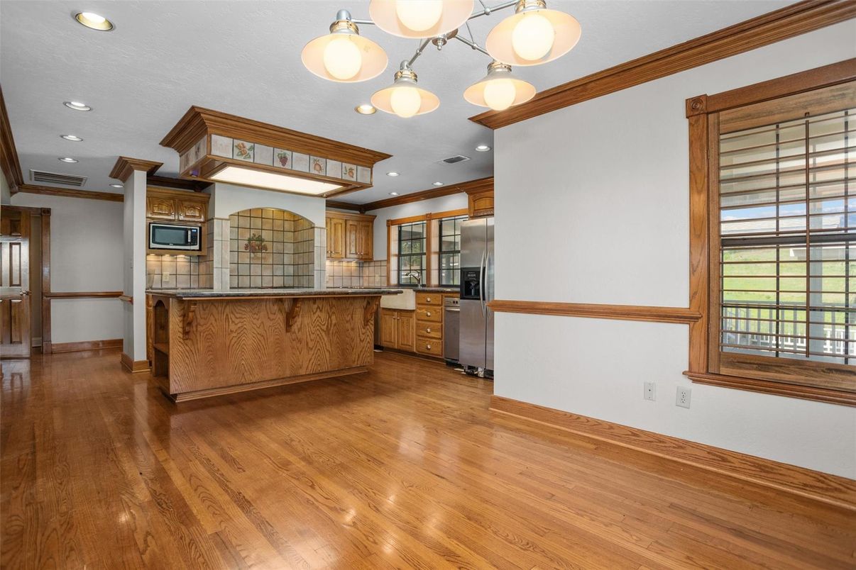 Interior, Kitchen, Pendant Lights, Recessed Lighting, Stainless Steel Appliances, Tile Countertops, Wood Texture Flooring