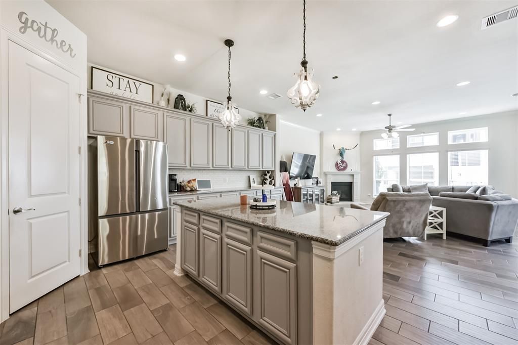 Fireplace, Interior, Kitchen, Living room, Pendant Lights, Recessed Lighting, Stainless Steel Appliances, Wood Texture Flooring