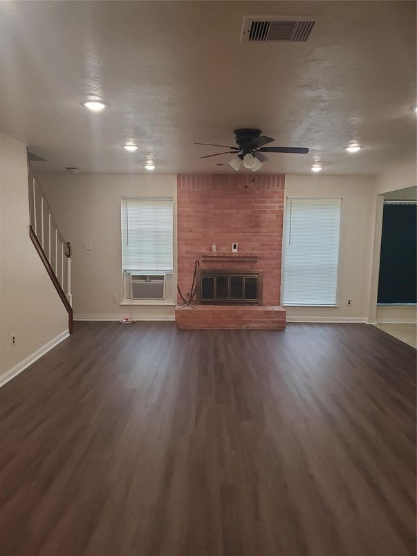 Empty room, Fireplace, Interior, Recessed Lighting, Stone Walls, Wood Texture Flooring