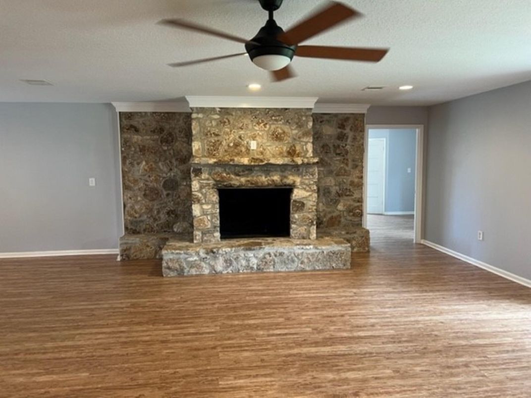 Empty room, Fireplace, Interior, Recessed Lighting, Stone Walls, Wood Texture Flooring