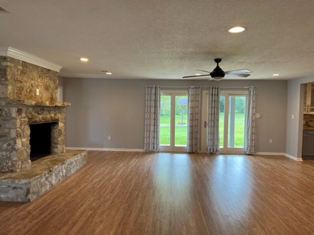 Empty room, Fireplace, Interior, Recessed Lighting, Stone Walls, Wood Texture Flooring