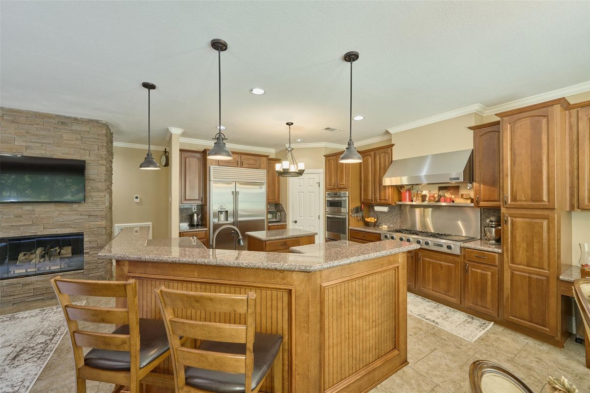 Fireplace, Interior, Kitchen, Pendant Lights, Recessed Lighting, Stainless Steel Appliances, Stone Walls