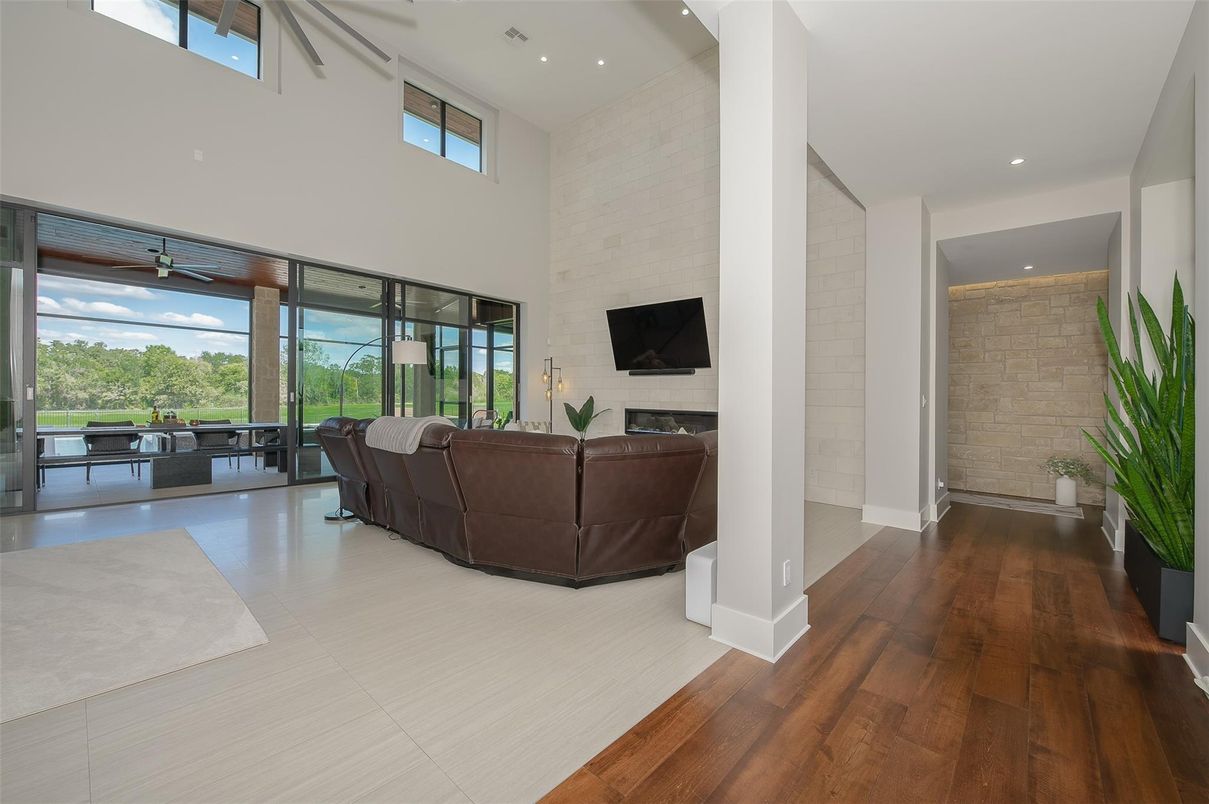 Fireplace, Interior, Living room, Recessed Lighting, Stone Walls, Wood Texture Flooring