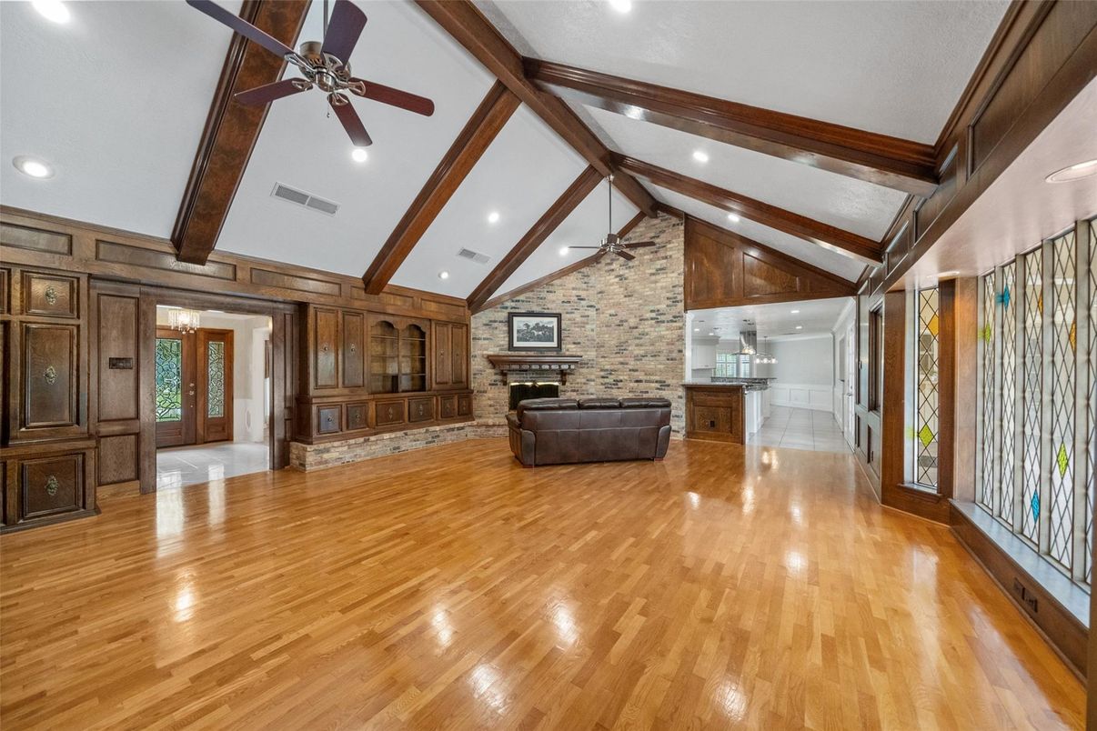 Empty room, Fireplace, Interior, Recessed Lighting, Stone Walls, Wooden Beams, Wood Texture Flooring