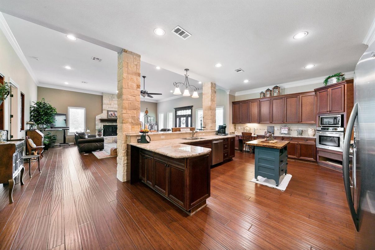 Fireplace, Interior, Kitchen, Living room, Recessed Lighting, Stainless Steel Appliances, Wood Texture Flooring