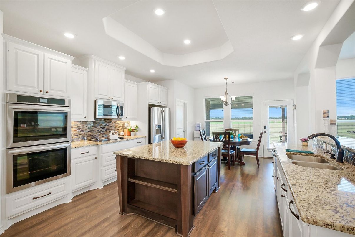 Chandelier, Dining room, Interior, Kitchen, Pendant Lights, Recessed Lighting, Stainless Steel Appliances, Water, Wood Texture Flooring