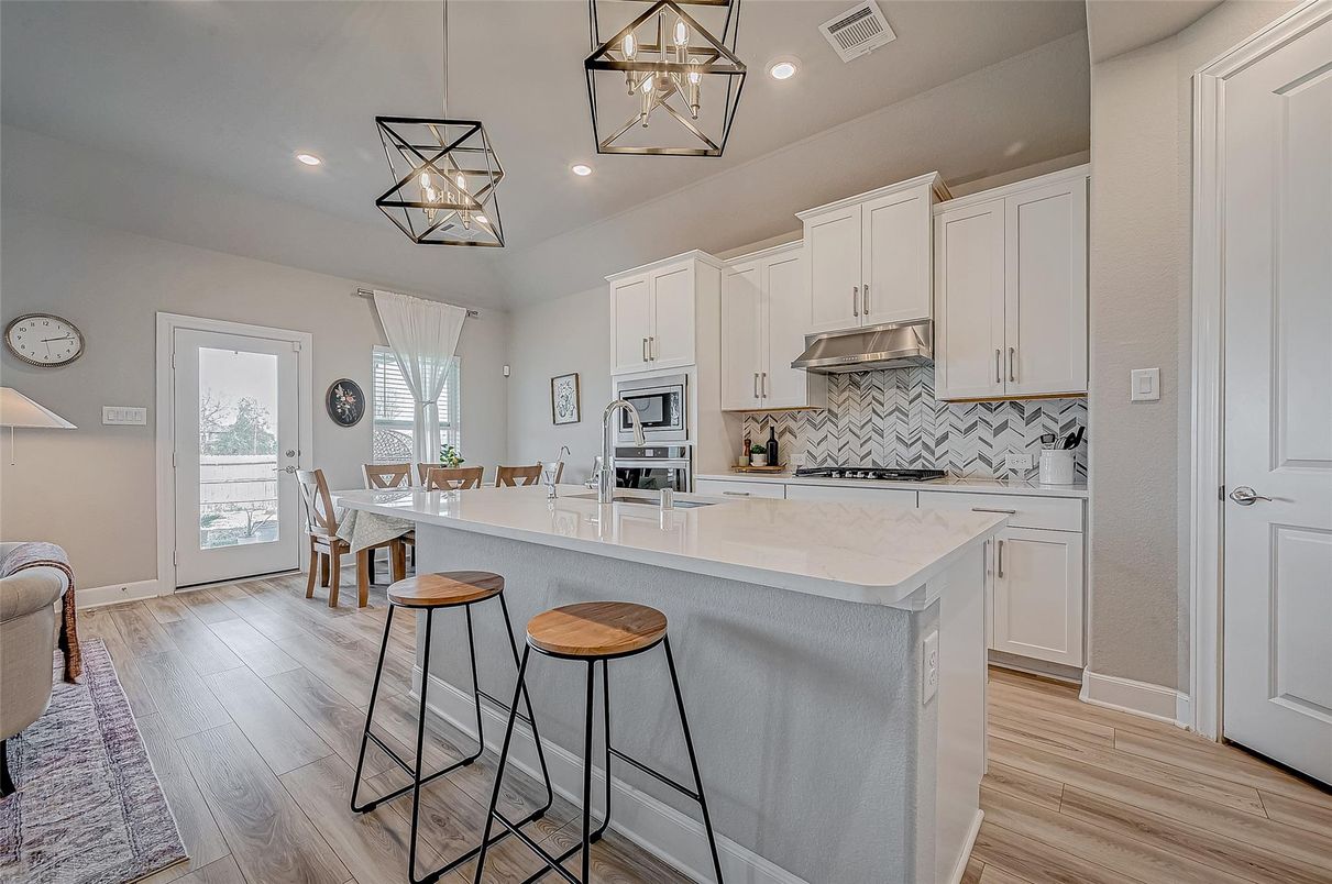 Dining room, Interior, Kitchen, Pendant Lights, Recessed Lighting, Stainless Steel Appliances, Wood Texture Flooring
