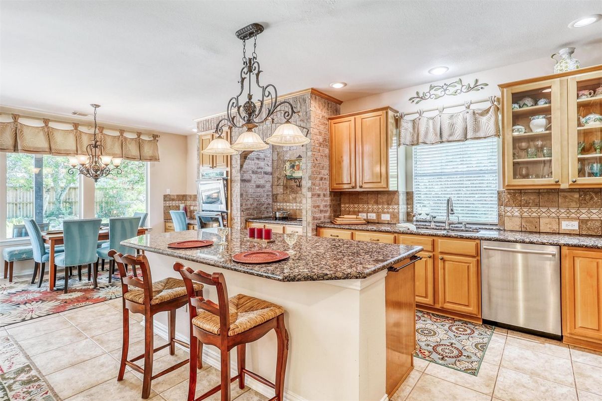 Chandelier, Dining room, Fireplace, Interior, Kitchen, Pendant Lights, Recessed Lighting, Stainless Steel Appliances, Stone Walls