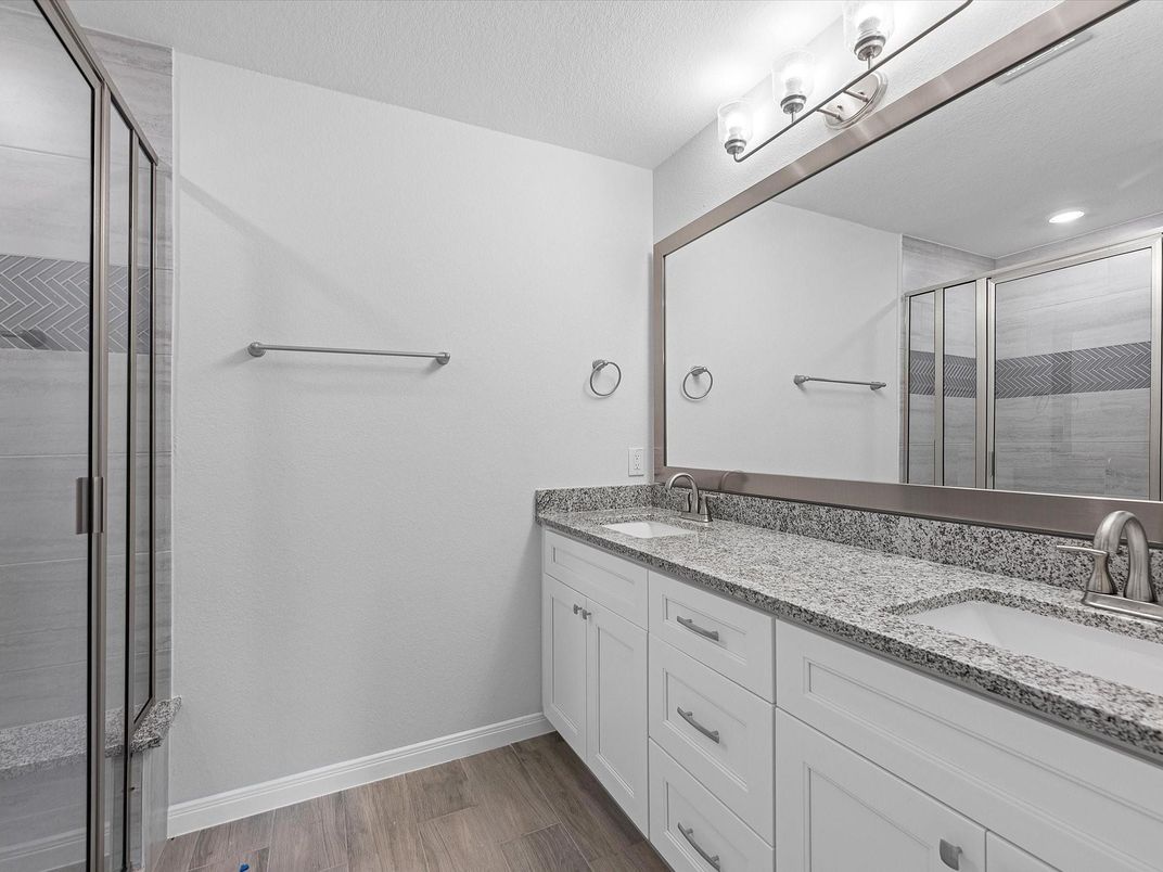 Bathroom, Dual Sink Vanities, Glass Shower, Interior, Recessed Lighting, Wood Texture Flooring
