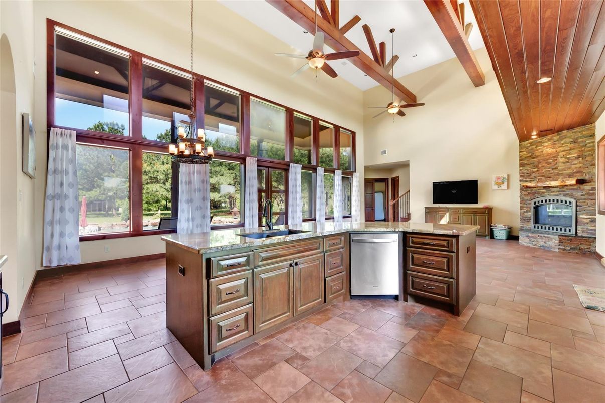 Fireplace, Interior, Kitchen, Pendant Lights, Recessed Lighting, Stainless Steel Appliances, Stone Walls, Wooden Beams