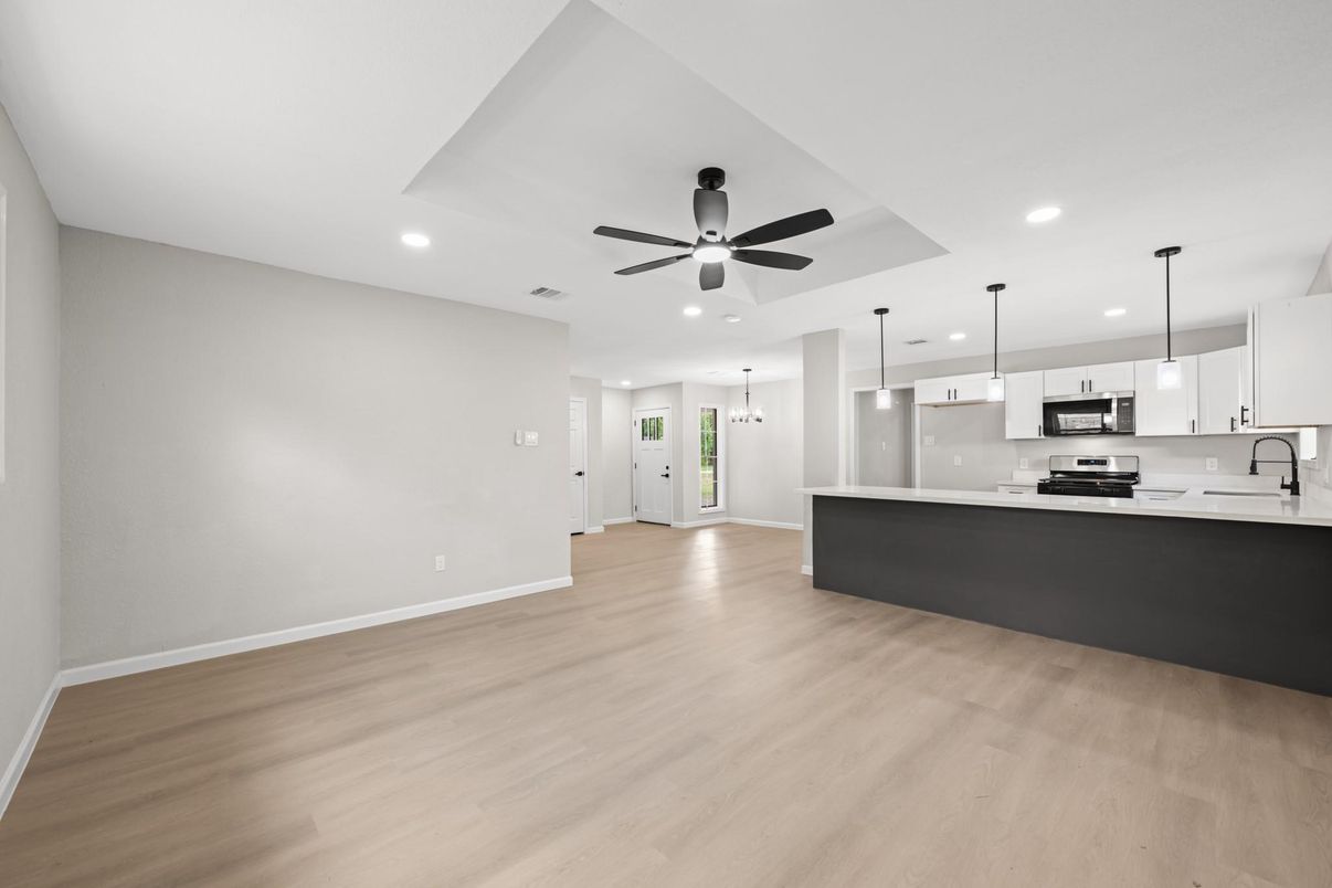 Empty room, Interior, Kitchen, Pendant Lights, Recessed Lighting, Stainless Steel Appliances, Wood Texture Flooring