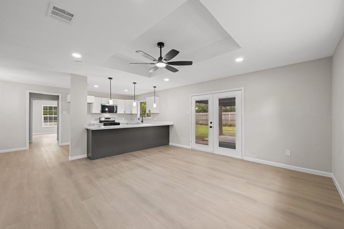 Empty room, Interior, Kitchen, Pendant Lights, Recessed Lighting, Stainless Steel Appliances, Wood Texture Flooring