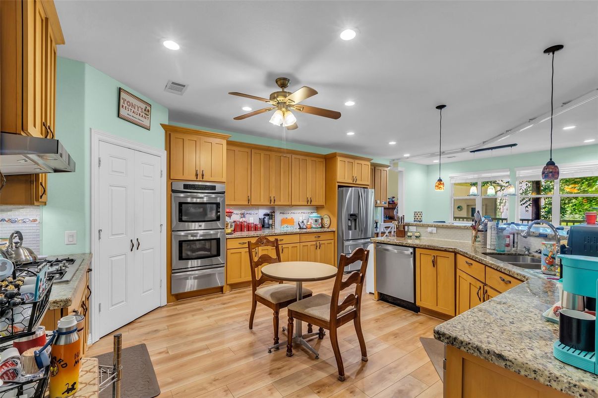 Dining room, Interior, Kitchen, Pendant Lights, Recessed Lighting, Stainless Steel Appliances, Wood Texture Flooring